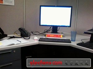 　　斯巴達(dá)式的簡(jiǎn)潔：兩臺(tái)電腦、水、電話和筆記本。